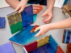 Photo of children playing with magnatiles.